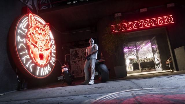 The Electric Fang Tattoo neon sign and entrance at night