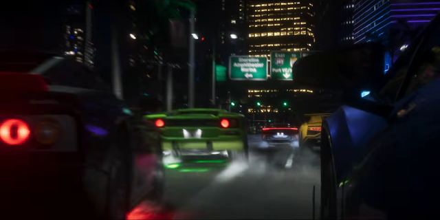A red sports car on the freeway at night. Still from official footage, Rockstar Games