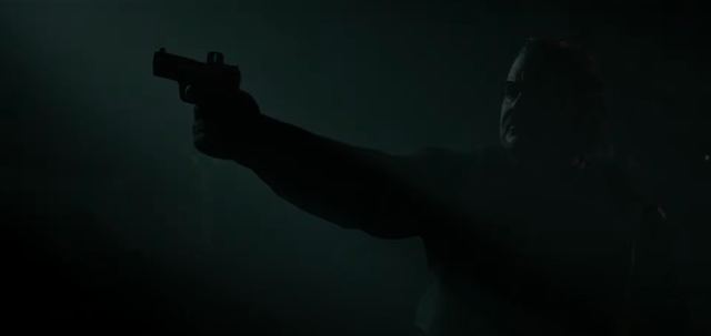 A pistol raised in the fog. Still from official footage, Rockstar Games